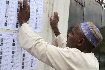 Mallam Sanni searches for his name on the list