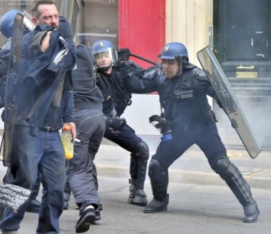 Riot police hit a protester  on November 1, 2014 in Nantes, western France, 