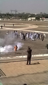 Aminu Tambuwal is one of the men in white walking away from the Assembly premises after been teargassed