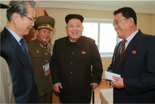 North Korean leader Kim Jong-Un with officials: Pyongyang innocent of hacking Sony Pictures?