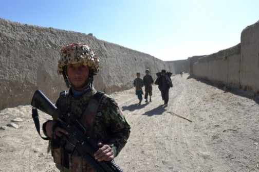 An Afghan soldier walking in the compound of the mosque where Mullah Omar founded the Taliban movement 20 years ago in the village of Sangesar