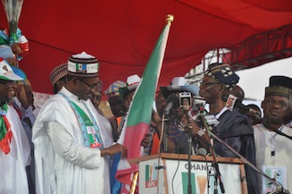 R-L: All Progressives Congress National Chairman, Chief John Oyegun presents presidential primary winner, Muhammadu Buhari with their party flag