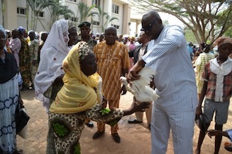 Stomach Infrastructure: Governor Ayo Fayose gives an elderly woman a chicken