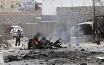 Security personnel gather at the scene of an explosion near the entrance of the airport in Somalia’s capital Mogadishu