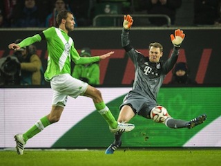 Wolfsburg's striker Bas Dost (L) shoots the ball during Wolfsburg's 4-1 thrashing of Bayern Munich