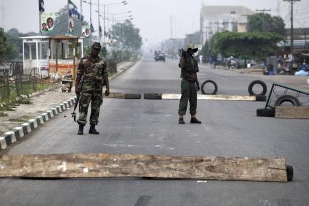 Soldiers mount a roadblock along an highway in Ikeja district, during parliamentary elections in Nigeria’s commercial capital Lagos