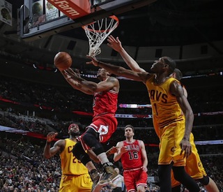 Derrick Rose goes for the basket in style