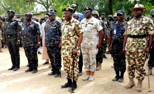 Jonathan, the C-I-C Taking the salute with service chiefs in Baga