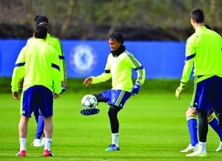Chelsea’s Juan Cuadrado (centre) controls the ball during a training session at Chelsea’s training ground south of London, yesterday ahead of tie against PSG tonight, AFP PHOTO