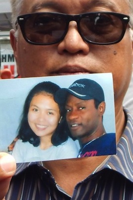 Utomo Karim, lawyer of Nigerian drug convict and death row prisoner Raheem Agbaje, holds a photo of his client Agbaje (R) with his girlfirend who has resigned to his fate, in Cilacap on April 26,