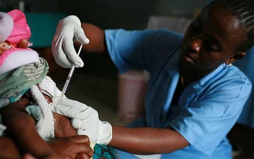 a nurse administers an experimental malaria vaccine on a child