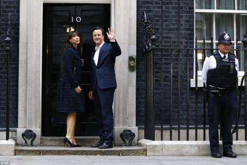 Cameron, with wife Samantha waves to  the British voters
