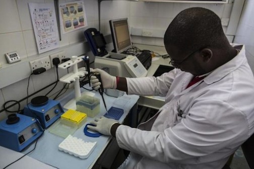 A lab technician works in the viral load room 