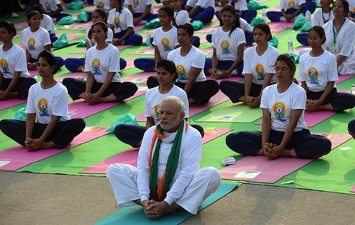 India’s Prime Minister Narendra Modi performs yoga with others during a yoga camp to mark the International Day of Yoga