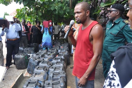 The apprehended petrol black market operator, Innocent Nwevo being questioned by newsmen at 1-3, Secretariat road, Oke-Ira, Ojodu LCDA, Lagos on Monday, July 13, 2015.