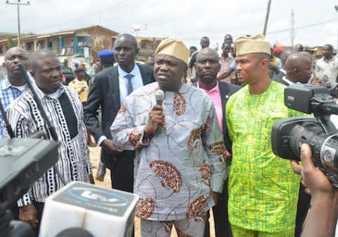 Lagos State Governor, Mr. Akinwunmi Ambode (middle) addressing residents after his inspection of Ikotun-Ejigbo-Isolo roads. With him are Federal Lawmaker, Hon. Jide Jimoh (left) and the Executive Secretary, Egbe-Idimu Local Council Development Area, Hon. Kunle Sanyaolu(right).