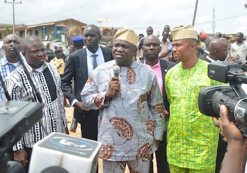 Lagos State Governor, Mr. Akinwunmi Ambode (middle) addressing residents after his inspection of Ikotun-Ejigbo-Isolo roads on Tuesday, July 14, 2015. With him are Federal Lawmaker, Hon. Jide Jimoh (left) and the Executive Secretary, Egbe-Idimu Local Council Development Area, Hon. Kunle Sanyaolu(right).