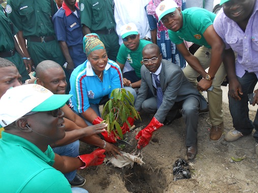 CAPTIONS: Representative of the Permanent Secretary, Ministry of Environment Mr. Densohin Olusegun (right) deputy Executive secretary, Lagos Island Local Government, Mrs. Iyabosola Eletu and other officials of the Local planting a tree during tree planting campaign exercise at the local government on Tuesday