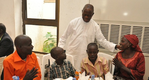 Governor Adams Oshiomhole and a family of Internally Displaced Persons at a reception by the Edo State Government for IDPs who have located their children before departing the state, on Sunday