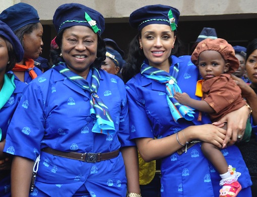 Mrs Iara Oshiomhole, (middle) carries a baby Girls Guide member, with her is Hon Elizabeth Ativie, member Edo State House of Assembly (left) at the National Camp of the Nigerian Girls Guide Association