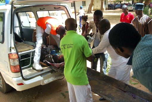 Health officials carry the body of a victim of a suicide bomb attack out of an ambulance in Potiskum, in northeast Nigeria’s Yobe State, on June 15, 2015 (AFP Photo:Aminu Abubakar)