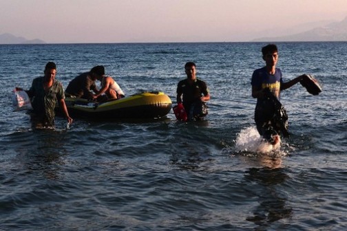 FILE PHOTO: A group of migrants arrives to the shore of Greece's Kos island on a small dinghy from Turkey, on August 18, 2015 (AFP Photo/Louisa Gouliamaki)
