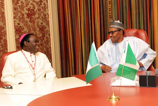 President Muhammadu Buhari and Bishop Mathew Hassan Kukah shares a joke