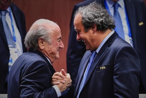 Suspended FIFA President Sepp Blatter (L) shakes hands with UEFA president Michel Platini