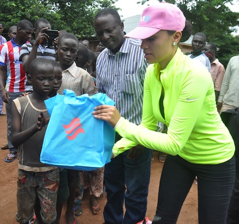 Mrs Iara Oshiomhole, wife of Edo State Governor, presents some items to Internally Displaced Persons at the IDP Camp.