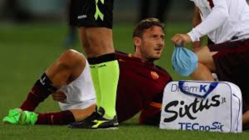 Francesco Totti, 39, gets the attention of the medical staff after a muscle injury