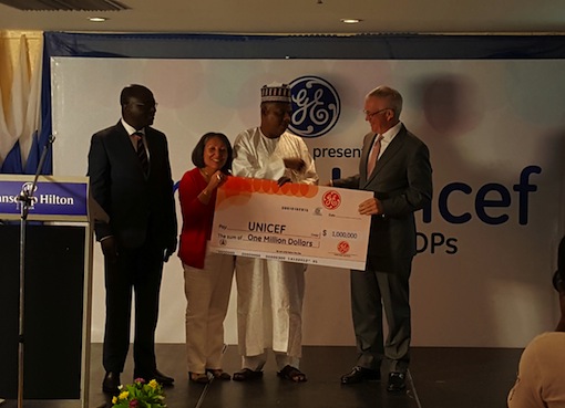 Dr. Lazarus Angbazo, President GE Nigeria and Jean Gough, President Unicef Nigeria looking on as Jay Ireland President GE Africa presents the cheque for $1m in support of IDPs to Gov. Kashim Shettima of Borno state at an event in Abuja