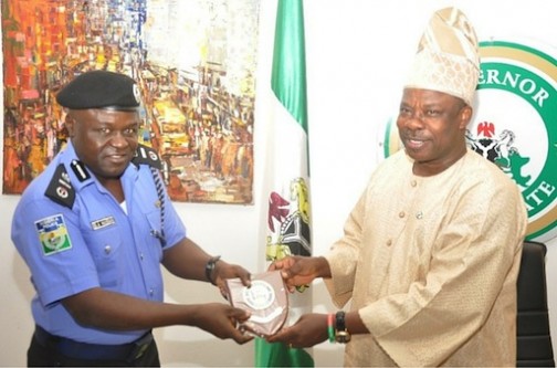 FILE PHOTO: Ogun State Governor, Senator Ibikunle Amosun (right), presenting the state's plaque to the AIG of Police in charge of Zone 2, Bala Hassan in Abeokuta, Ogun State capital