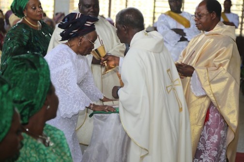 Mama Lucia Onabowale Onabanjo takes Holy Communion during the church service in her honour.  Photo: Idowu Ogunleye/PM News
