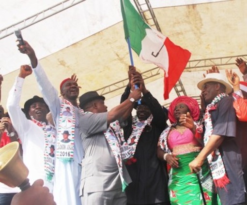 Governor Dickson (3rd r), being presented with the governorship flag by the Acting PDP National Chairman, Prince Uche Secondus (3rd L), amidst applause from the Bayelsa State Deputy Governor, Rear Admiral John Jonah (rtd), (r), wife of the Governor, Dr. (Mrs) Rachael Dickson (2nd r), Speaker, BYHA, Konbowei Benson (L), and the PDP National Vice Chairman, South/South, Dr. Cairo Ojougboh (2nd l), during the Governorship Flag Presentation Rally, ahead of the Dec. 5, governorship election in the State, at the Samson Siasia Stadium, Yenagoa