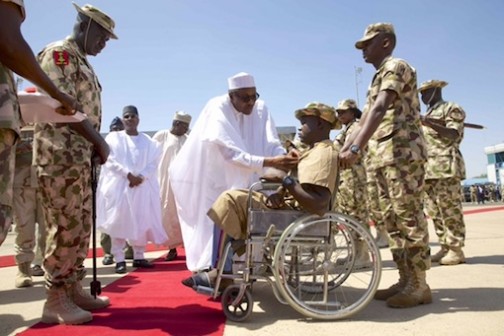 President Muhammadu Buhari honours an injured soldier