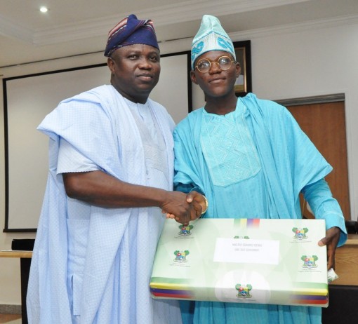 Lagos State Governor, Mr. Akinwunmi Ambode, presenting a gift to the One Day Governor, Master Idowu Sonoiki, during his visit to the Governor at the EXCO Chamber, Lagos House, Ikeja, on Wednesday, November 04, 2015.