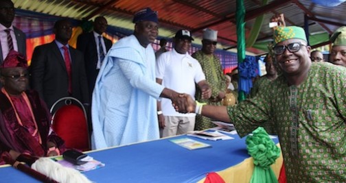 Lagos State Governor, Mr. Akinwunmi Ambode (2nd left) congratulating the Chairman, Akogo-Alara Ikorodu North CDC, Mr. Laja Martins as the Best CDA in the State, during the Year 2015 Community Day Celebration with the theme - Community Development: Tool for Sustainable Development, at the Police College Parade Ground, G.R.A, Ikeja, Lagos, on Thursday, November 12, 2015. With them are Oba of Lagos, Oba Rilwan Akiolu I; Commissioner for Local Government & Community Affairs, Hon. Muslim Folami and Chairman, Local Government Service Commission, Mr. Babatunde Rotinwa