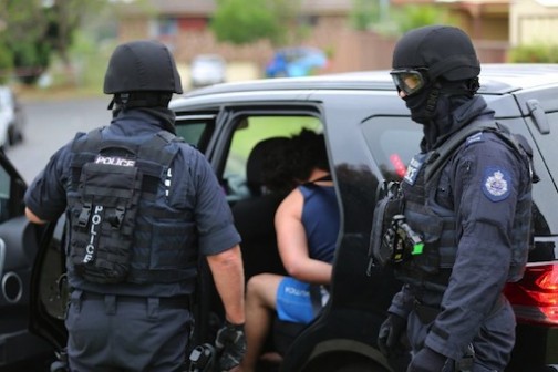 A man is being arrested during a counter-terrorism raid in Sydney  Photo: AFP