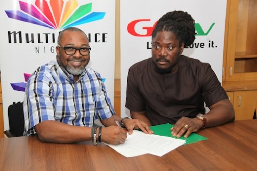 L-R: John Ugbe, Managing Director, MultiChoice Nigeria signing the contract paper with Daddy Showkey as GOtv Ambassador