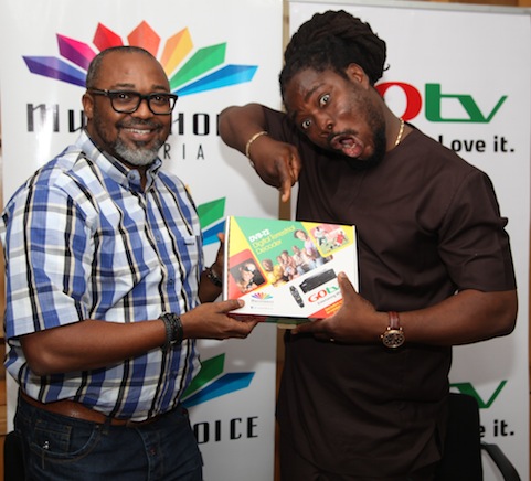 L-R: John Ugbe, Managing Director, MultiChoice Nigeria signing the contract paper with Daddy Showkey as GOtv Ambassador