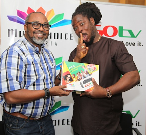 L-R: John Ugbe, Managing Director, MultiChoice Nigeria signing the contract paper with Daddy Showkey as GOtv Ambassador.