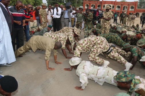  Minister of Information and Culture Alhaji Lai Mohammed in a push-up with the military in Bama during his visit to some towns liberated by the military from Boko Haram in Borno State. 
