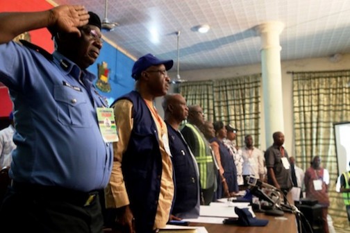 INEC officials and security personnel observing the National Anthem Photo: Idowu Ogunleye