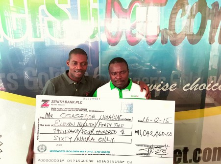 L - R: The General Manager of Winners Golden   Bet, Mr. Ayowole Sajimi presenting a cheque of over N11 million to