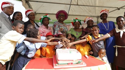 Wife of Lagos State Governor, Mrs. Bolanle Ambode (middle); Managing Director, Lagos State Parks & Gardens Agency (LASPARK), Dr. (Mrs.) Titilayo Anibaba (3rd right), jointly cutting the cake with other Senior Officers of the Agency and pupils, during the LASPARK 2015 Christmas Family Fun Share celebration at the Ndubuisi Kanu Park, Alausa, Ikeja, on Tuesday, December 15, 2015.