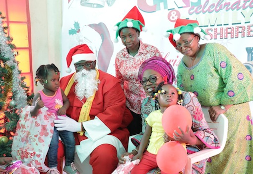 Wife of Lagos State Governor, Mrs. Bolanle Ambode (right) with Santa Claus and the  Managing Director, Lagos State Parks & Gardens Agency (LASPARK), Dr. (Mrs.) Titilayo Anibaba (right, behind), presenting gifts to children, during the LASPARK 2015 Christmas Family Fun Share celebration at the Ndubuisi Kanu Park, Alausa, Ikeja, on Tuesday, December 15, 2015.