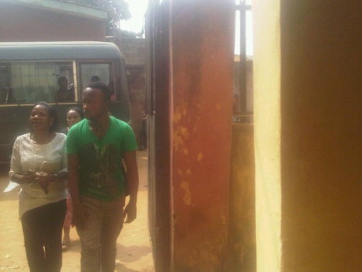 Alaba trader Chidiebere Udeze charged with diverting bicycles worth N2.2m, being escorted by a police woman at Ejigbo court on Monday, 11 Jan. 2016