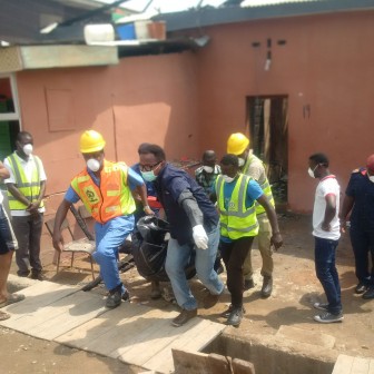 The remains of a 65-year-old woman burnt to death by cultists in Bariga, Lagos being taken away by LASEMA officials on Saturday, 23 Jan. 2016