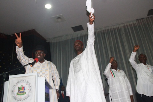 L – R: Bayelsa State Governor, Hon. Seriake Dickson, PDP National Vice President, South-South, Dr. Cairo Ojuogbo, Special Adviser to the Bayelsa State Governor on Political Matters, Mr. Fyneman Wilson, and the State SSG, Dr. Edmond Allison Oguru, acknowledging cheers from the audience, during a meeting of all political appointees in the State, at the Banquet hall, Government House, Yenagoa. Photo by Michael Owi.