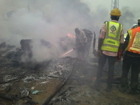 FILE PHOTO: Fire service men and LASEMA personnel battle to put out the fire